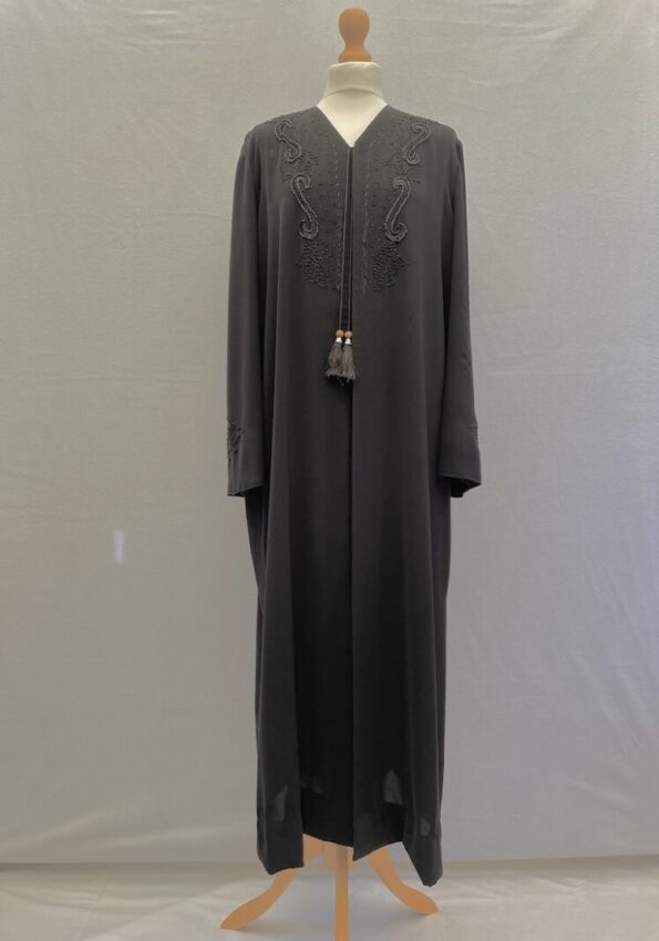 Beautiful black abaya overjacket with beading. Button front opening. Side splits and two tassels. 50" long, 23" across